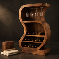 Corner detail of s shaped open bar cabinet with a glass rail and tiered bottle shelves beside wood, brass and linen samples