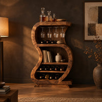 S shaped open bar cabinet with a glass rail and tiered bottle shelves in a dark dining room at golden hour