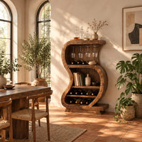 S shaped open bar cabinet with a glass rail and tiered bottle shelves in a bright dining room with arched windows and plants