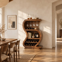 S shaped open bar cabinet with a glass rail and tiered bottle shelves in a bright open plan dining room