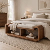 Curved bench with a tufted seat cushion and two open cubbies below in a Scandinavian bedroom with white walls
