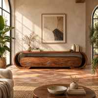 Low tv stand with a looped frame and three wave carved fronts in a bright living room with arched windows and plants