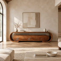 Low tv stand with a looped frame and three wave carved fronts in a bright open plan living room