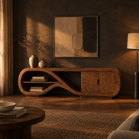 Tv stand with a looping ribbon shelf and a two door cabinet in a dark living room at golden hour