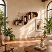Stepped s shaped wall shelf with open cubbies of different sizes in a bright living room with arched windows and plants