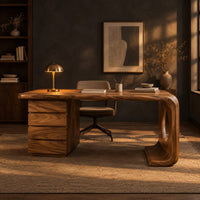 Desk with a drawer pedestal and a curved leg with a round cutout in a dark home office at golden hour
