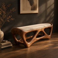 Cushioned bench with an open lattice wood base, three-quarter view showing the grain