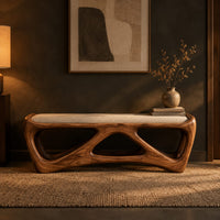 Cushioned bench with an open lattice wood base in a dark entryway at golden hour