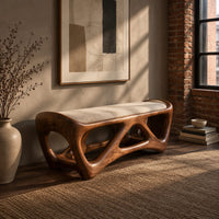 Cushioned bench with an open lattice wood base in an industrial loft entryway with exposed brick