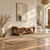 Cushioned bench with an open lattice wood base in a bright open plan entryway