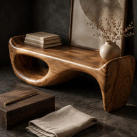Corner detail of cushioned bench with a sweeping sculpted body and an oval cutout beside wood, brass and linen samples