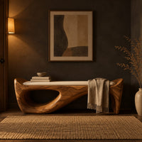 Cushioned bench with a sweeping sculpted body and an oval cutout in a dark entryway at golden hour