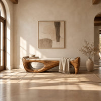 Cushioned bench with a sweeping sculpted body and an oval cutout in a bright open plan entryway