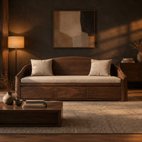Daybed style sofa with an arched back and a three panel wood front in a dark living room at golden hour
