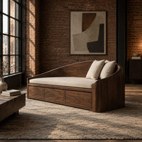 Daybed style sofa with an arched back and a three panel wood front in an industrial loft living room with exposed brick