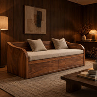 Daybed style sofa with swept wood sides, paneled base and a long seat pad in an evening living room with walnut wall paneling