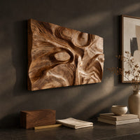Detail of deep carved wooden wall relief with an oval eye and flowing swirls beside wood, brass and linen samples