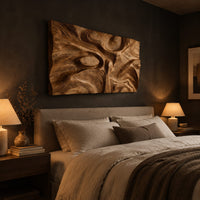 Deep carved wooden wall relief with an oval eye and flowing swirls above a bed in a dusk lit bedroom