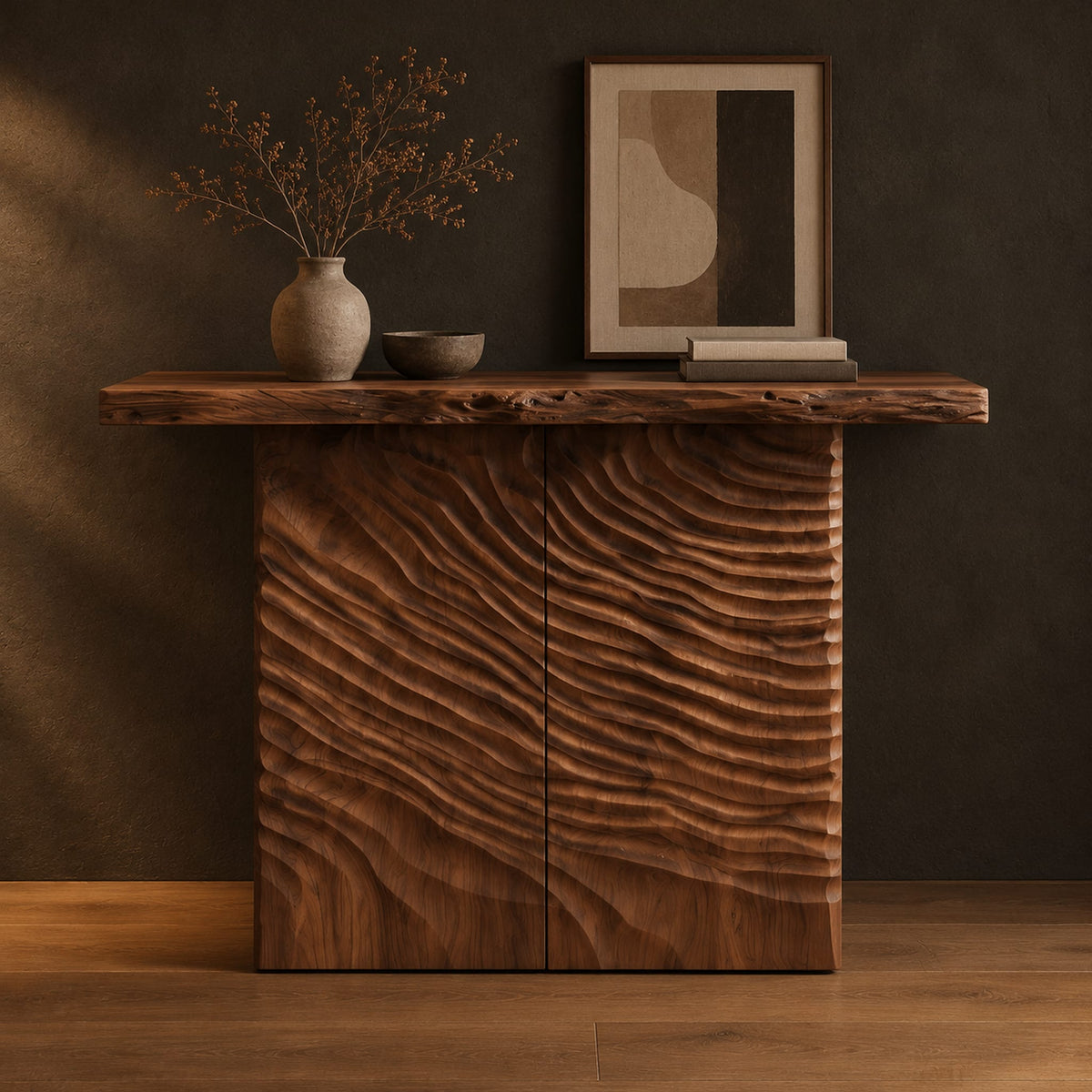 Wooden console table with a live edge top and a deeply carved front in a dark studio against a charcoal plaster wall