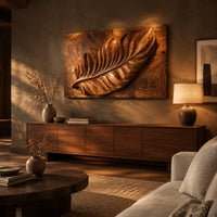 Rectangle wooden wall panel with a deep relief leaf carved across swirling grain above a low console in an evening living room