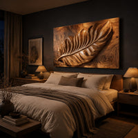Rectangle wooden wall panel with a deep relief leaf carved across swirling grain above a bed in a dusk lit bedroom