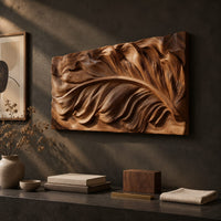 Detail of wide carved wood relief panel of a sweeping feather with flowing layered barbs beside wood, brass and linen samples