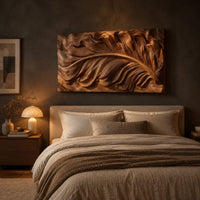 Wide carved wood relief panel of a sweeping feather with flowing layered barbs above a bed in a dusk lit bedroom