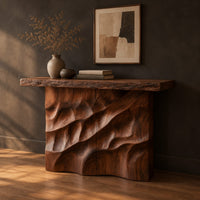 Console table with deep diagonal ripple carving on a solid base, three-quarter view showing the grain