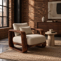 Deep seat lounge chair with thick looped wood arms and a lumbar pillow in an industrial loft living room with exposed brick