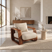 Deep seat lounge chair with thick looped wood arms and a lumbar pillow in a bright open plan living room