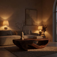 Dark coffee table with a deep U shaped open shelf in an evening room lit by two lamps