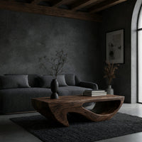 Dark coffee table with a deep U shaped open shelf in a concrete and timber loft
