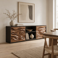 Low wooden sideboard with wave carved door panels and an open center bay in a Scandinavian dining room with white walls