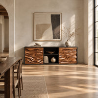 Low wooden sideboard with wave carved door panels and an open center bay in a bright open plan dining room
