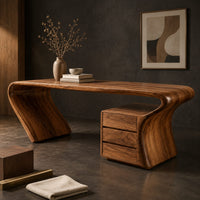 Corner detail of desk with a top that flows into a slanted leg and drawer pedestal beside wood, brass and linen samples