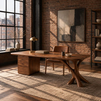 Wide desk with a forked limb leg and a three drawer pedestal in an industrial loft home office with exposed brick