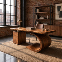 Desk with a sweeping scroll base and a three drawer pedestal in an industrial loft home office with exposed brick