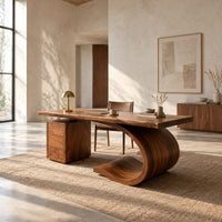 Desk with a sweeping scroll base and a three drawer pedestal in a bright open plan home office