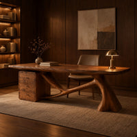 Wooden desk with a swooping single leg and a stacked drawer block in an evening home office with walnut wall paneling