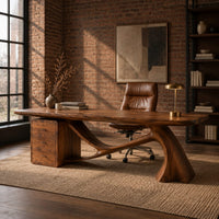 Wooden desk with a swooping single leg and a stacked drawer block in an industrial loft home office with exposed brick