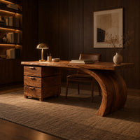 Wood desk with three stacked drawers and one sweeping curved leg in an evening home office with walnut wall paneling
