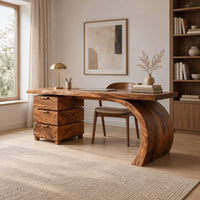 Wood desk with three stacked drawers and one sweeping curved leg in a Scandinavian home office with white walls