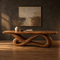 Wooden desk with a smooth slab top on a twisting infinity loop base in a dark studio against a charcoal plaster wall