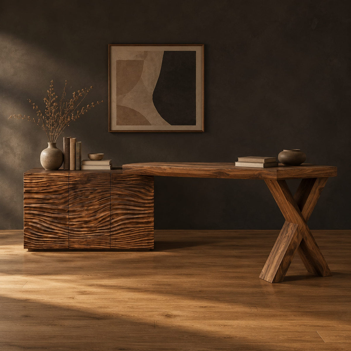 Wooden desk with a wave carved cabinet block and an x shaped leg in a dark studio against a charcoal plaster wall