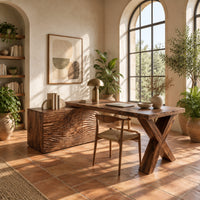 Wooden desk with a wave carved cabinet block and an x shaped leg in a bright home office with arched windows and plants