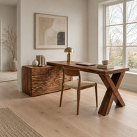 Wooden desk with a wave carved cabinet block and an x shaped leg in a Scandinavian home office with white walls