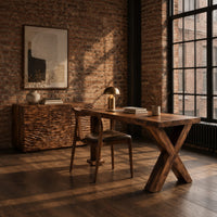 Wooden desk with a wave carved cabinet block and an x shaped leg in an industrial loft home office with exposed brick