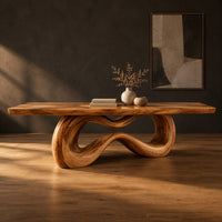 Rectangular dining table on a looping ribbon pedestal base in a dark studio against a charcoal plaster wall