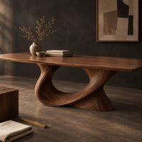 Corner detail of dining table on a single sweeping pedestal with an oval opening beside wood, brass and linen samples