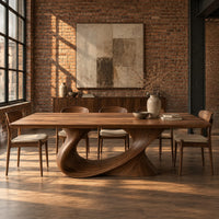 Dining table on a single sweeping pedestal with an oval opening in an industrial loft dining room with exposed brick